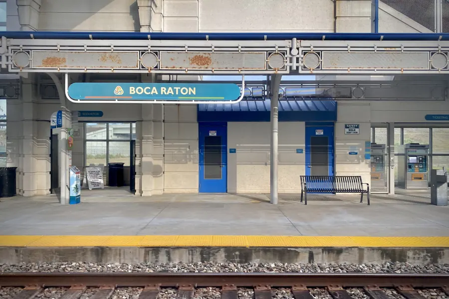 The Tri-Rail platform at Boca Raton, its station sign above an empty bench
